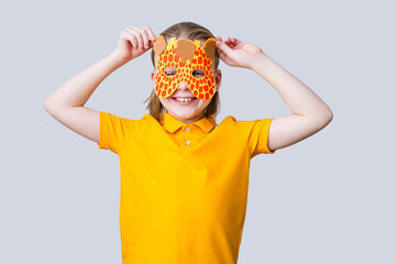 Cute giraffe on a gray background. A child in a handmade carnival mask. Play accessories, photo booth props for kids. isolated