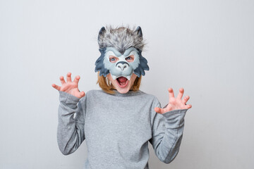 The roar of a wolf, isolated on a gray background. Early child development and imagination. Play...
