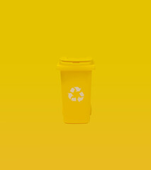 Yellow Recycling Bin On A Uniform Yellow Background Signifying Waste Segregation.