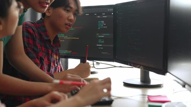 Back end software developer engineer for computer programming working together on debugging writing computing code, solving complex algorithms display on monitor in office. Burgeoning