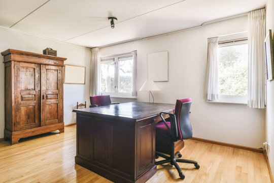 Spacious home office with wooden furniture