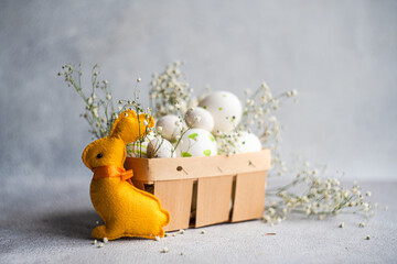 Plush Easter bunny with decorated eggs and baby's breath