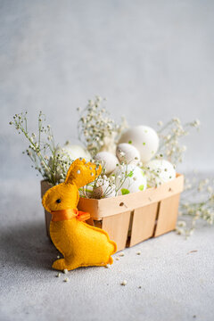 Plush Easter bunny with decorated eggs and baby's breath