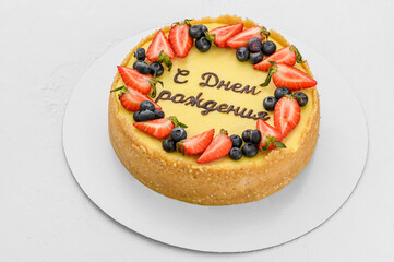 cheesecake cake with berries on a white background