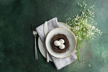 Elegant spring table setting with nest and eggs