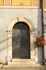 Fototapeta na wymiar Old street in historical town, beautiful old door with Plants decorations. Classic european architecture. Postcard concept. Travel inspiration, Luxury estate background