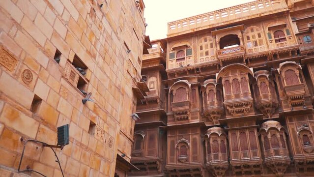 Patwon ki Haveli at Jaisalmer in Rajasthan, India. Birds flying against palace. Heritage Tourist Attraction in Rajasthan. Old Royal architecture in Jaisalmer made of sand stones.