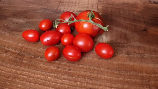 Red green yellow cherry tomatoes on wooden table