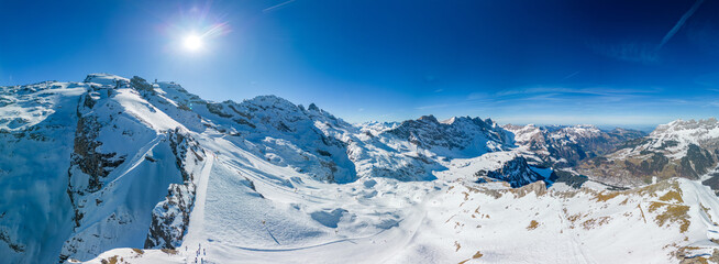 Aerial panoramic winter landscape in Swiss Alps, famous Engelgerg - Titlis ski resort, Switzerland