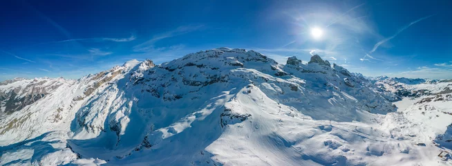 Schilderijen op glas Aerial panoramic winter landscape in Swiss Alps, famous Engelgerg - Titlis ski resort, Switzerland © Martin Valigursky