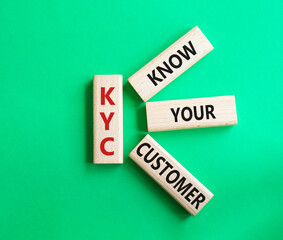 KYC - Know Your Customer. Wooden cubes with word KYC. Beautiful green background. Business and Know Your Customer concept. Copy space.