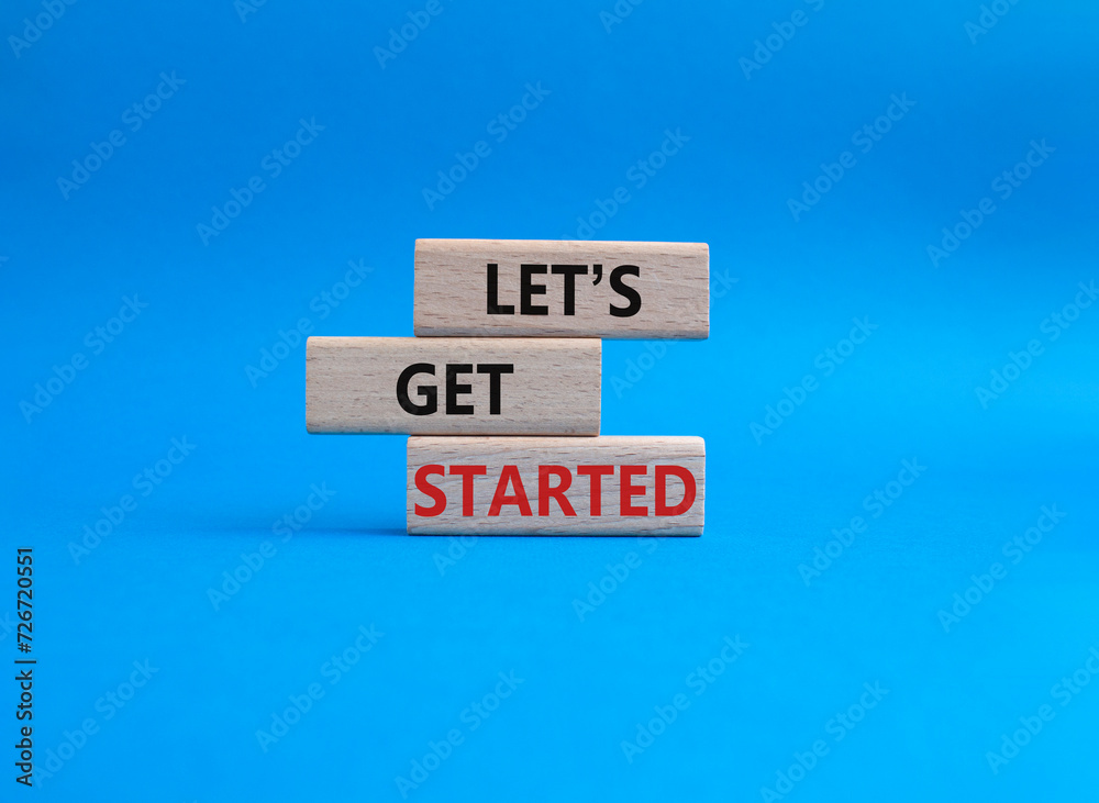 Canvas Prints lets get started symbol. concept words lets get started on wooden blocks. beautiful blue background.