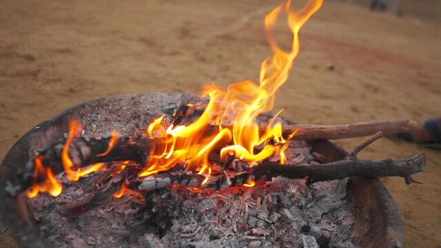 Closeup of fire in desert during camping, adventure. Bonfire in Thar desert at Jaisalmer, Rajasthan, India. 