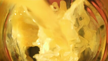 Fresh tangerine juice is poured into a glass. Filmed on a high-speed camera at 1000 fps. High quality FullHD footage - Powered by Adobe