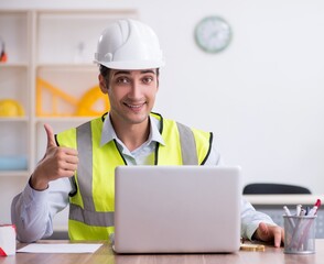 Young male architect working in the office