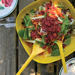 bowl with fresh summer salad on wooden table