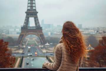 Back view of young woman tourist standing in front of Eiffel Tower in Paris. Tourism concept