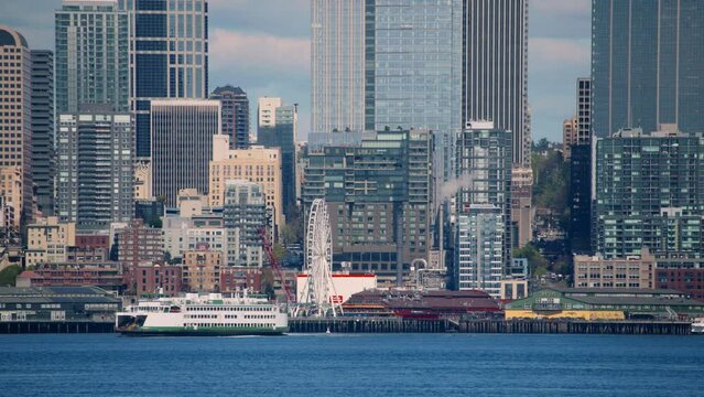 Fery Boat And Ferris Wheel in Seattle Waterfront Background