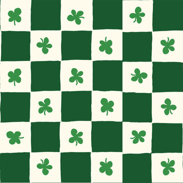 Seamless vector repeating pattern with hand drawn checkerboard in green and cream and a four leaf clover shamrock. St Patricks day lucky clover background.
