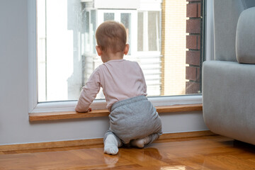 Child sees outside from window, wishes to go out. Concept of wanting to explore