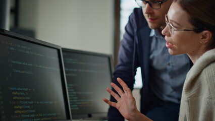 Software team consulting office closeup. It engineer supervisor teaching intern