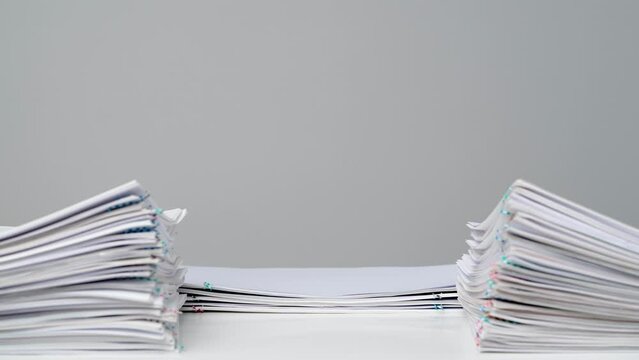 Time lapse studio shot of paper sheets. Stop motion animation of business or educational paper documents stack decreasing at the desk
