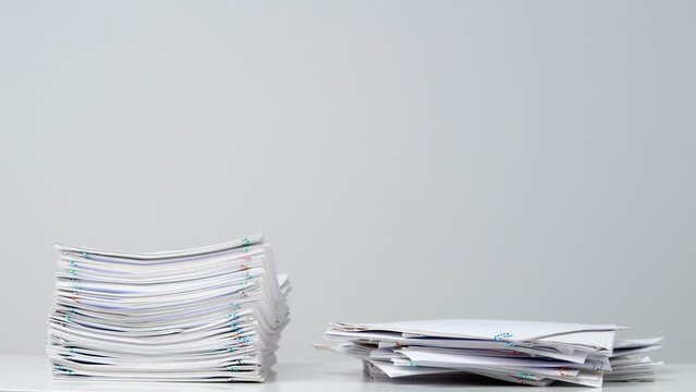 Time lapse shot of paper sheets. Stop motion animation of business or educational paper documents with paper clips increasing and decreasing.