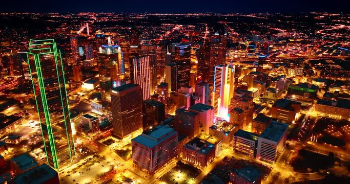 Footage rising above the dazzling well-lit panorama of Dallas, Texas, USA. Breath-taking view of metropolis at night.