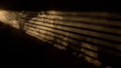 Studio shot of projector haze jalousie effect isolated on black background. Warm yellow light rays...