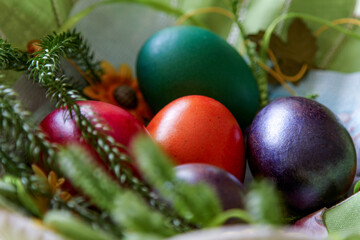 Fototapeta na wymiar Easter Eggs. Colored Easter Eggs in a Basket. Easter Egg in Nest on Vintage Background with Copy Space.