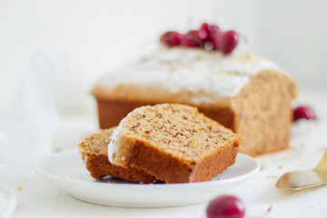 Homemade nut cake with cherrys on white background. Aesthetic breakfast concept.