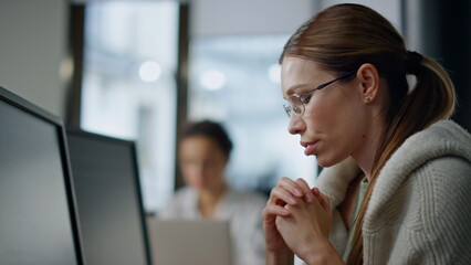 Pensive developer analyzing software closeup. Thoughtful woman looking computer
