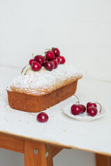 Homemade nut cake with cherrys on white background. Aesthetic breakfast concept.