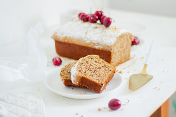 Homemade nut cake with cherrys on white background. Aesthetic breakfast concept.