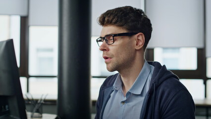 Pensive entrepreneur looking computer at office closeup. Stressed man developer