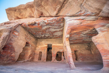 A colourful sandstone cut out cave in the city of Petra in Jordan 