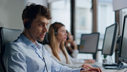 Stressed call center worker speaking headset closeup. Annoyed man specialist