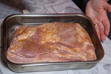 Pork belly steak seasoned with thyme, red onion, garlic and tomato sauce, stages of preparation