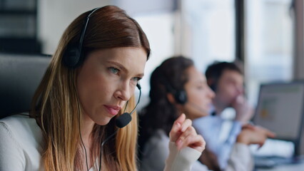Annoyed telemarketing operator talking client closeup. Angry woman listening