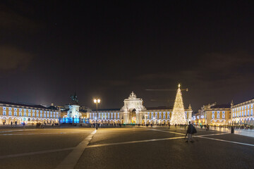 Fototapeta na wymiar Praca do Comercio in portuguese capital during christmas time in the night with illumination and christmas tree, Lisbon, Portugal