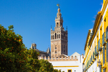 Fototapeta na wymiar View of Giralda - tower of the catholic cathedral in the city of Sevilla on a sunny day