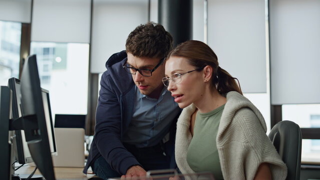 It supervisor helping colleague at workplace. Friendly man engineer consulting