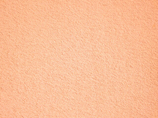 Abstract trendy background. Gentle peach color background Peach Fuzz plaster texture.