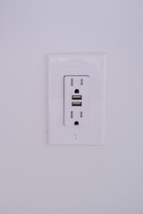 American electrical outlet with usb connectors close up on a wall