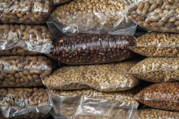 Large wholesale bulk bags of beans and nuts for sale at market