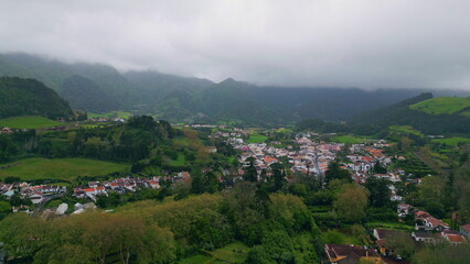 Country houses mountain valley landscape aerial view. Gloomy green hills village