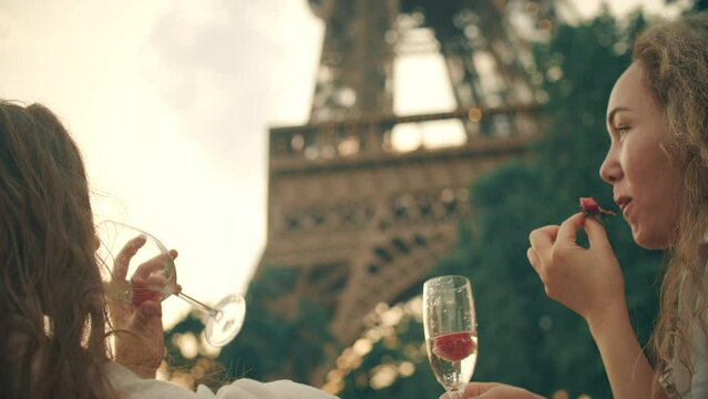 Young woman having picnic at the Eiffel Tower in Paris, France