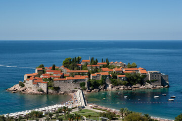 View of the island of St. Stephen at sunny day, Montenegro. Aman Sveti Stefan for publication, poster, screensaver, wallpaper, postcard, banner, cover, post. High quality photo