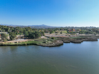 Fototapeta na wymiar Aerial view over water reservoir and a large dam that holds water. Rancho Santa Fe in San Diego, California, USA