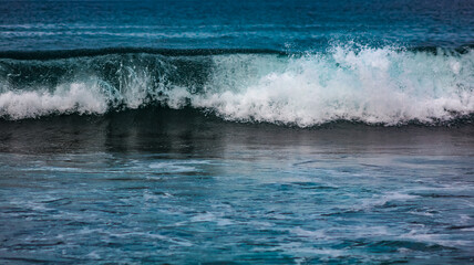waves and foam of sea water with clear water on one of the beaches on the island of Lombok, Indonesia